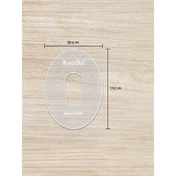 Kaio-Patch Template for CGM sensor patch on a wooden surface, dimensions labeled 8cm by 11cm.