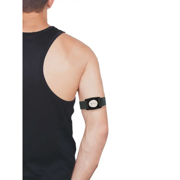 Dexcom G7 grey adjustable armband with rotating clip worn by person in black tank top.