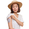 Dexcom G7 patch with spring design on woman's arm wearing a hat and white shirt.