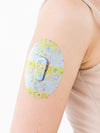 Dexcom G6 sensor patch from Childhood Memories Collection on arm, showcasing vibrant design and secure fit.