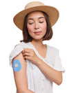 FreeStyle Libre 3 drop shape patch worn on a woman’s arm, with breathable adhesive fabric for sensor support