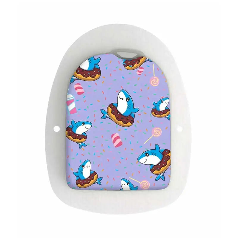 A colorful Omnipod POD sticker featuring cute blue sharks floating in donuts on a purple background adorned with candy and sprinkles. Image