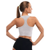 Woman wearing grey insulin pump adaptive crop top and black shorts, showcasing back and fit.
