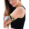 Woman wearing a yellow and black Freestyle Libre 3 Arm Band on upper arm while checking glucose monitor reading