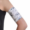 Blood glucose monitor armband in gray camo pattern on arm.