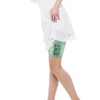 Woman wearing a green lace garter leg band securely holding an insulin pump under a white dress