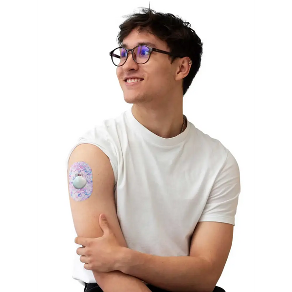 Smiling man using Guardian Enlite with adhesive patches for a secure hold