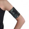 Stylish blood glucose sensor armband in dark printed fabric on arm.